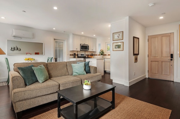 Comfortable couch and great room, extending into the dining area and kitchen.