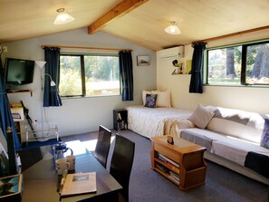 Living Room made up with 1 King-single Bed. Access to Patio.