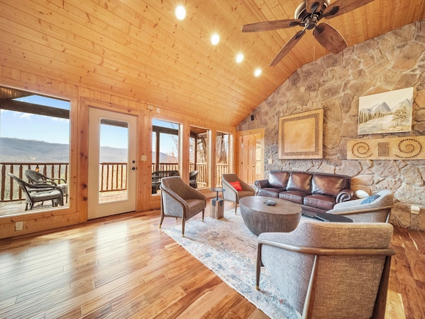 Spacious Living Room with Panoramic Mountain Views Through Grand Windows