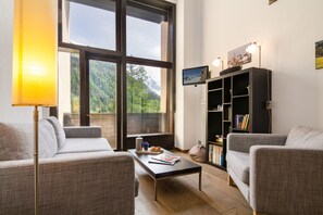 Bright living room with HDTV and a panoramic mountain view