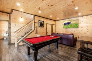 Full size pool table in the downstairs game room with large tv