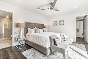 Spacious master bedroom with king-size bed, ensuite bathroom, and designer built-in closets. Equipped with lamps, hangers, luggage racks, alarm clock, white noise machine, and a 43" Samsung Smart 4K TV with streaming and DIRECTV Entertainment.