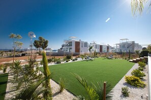 Garden complete with barbecue, seating area, dining area, sun loungers and pool