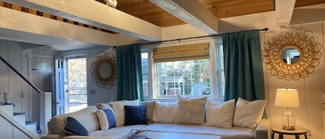 Sunny living room with vaulted ceilings and comfortable family seating 