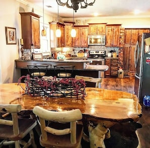 Dining room looking into kitchen. Table seating for 4 with 2 bar seats!