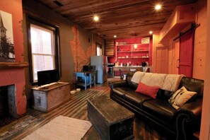 Curl up with a warm cup of coffee on our beautiful, leather sofa,  prop your feet up on the vintage coffee table,  and relax watching your favorite shows on the flat screen tv. 