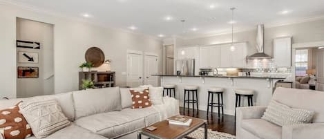 Our downstairs living space is as cozy as they come! An open living --> kitchen lends itself to good conversation & the comforts of home! Featuring bar seating & all new appliances in the kitchen plus plenty of pillows & blankets in the living room. 