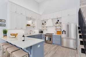 Our kitchen is what dreams are made of. Perfect for hosting larger groups, this modern kitchen is fully stocked and detailed with new high-end appliances, sleek brass hardware, soft close cabinets, and plenty of bar seating.