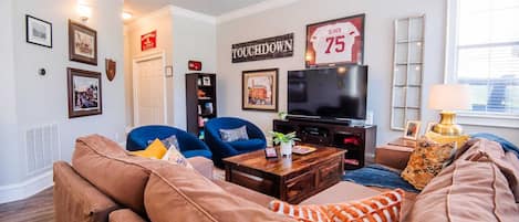 Enjoy Arkansas Razorback decor unlike any you'd find elsewhere! Featuring our owner's football jersey from his years playing for the Hogs displayed over HDTV. Snuggle up on our super comfy sectional or sleep a 5th member if needed.