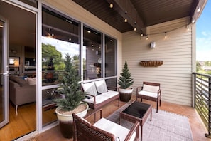 Enjoy your morning coffee on our serene patio - complete with cozy seating, plants, and twinkle lights.