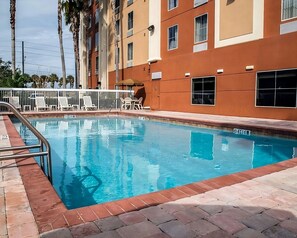 Large heated swimming pool and poolside loungers