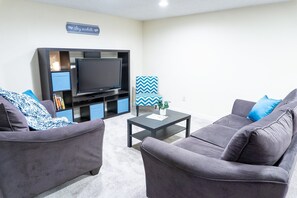 Cozy seating area, TV with Roku. The larger couch has a queen sized sofa bed.