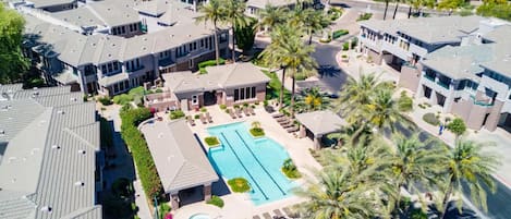 Gated condominium complex with pool, hot tub, gym, and BBQ grills.