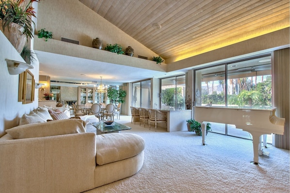 Living room features high-beamed ceiling, wet bar and Baby Grand Piano