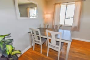A warm and inviting dining area with natural light, elegant furnishings, and a cozy ambiance—perfect for shared meals and conversations.