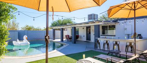 Brand new outdoor renovation with pool house, built-in BBQ, patio lights, turf, and new furniture!