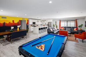 Open concept living area with pool table and dining area.