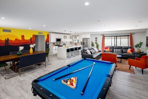 Open concept living area with pool table and dining area.