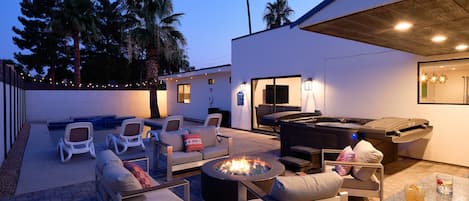 Large private resort-like backyard featuring a sparkling blue pool, hot tub, fire pit, BBQ grill, plenty of outdoor seating, and a built-in bar.