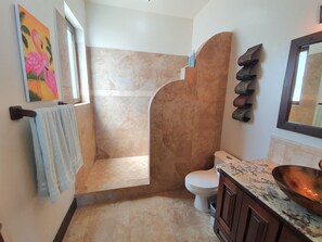 Private bathrooms with tile walk in showers.