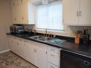 Kitchen offers dishwasher, pots and pans, knives, eatery, and basic spices.