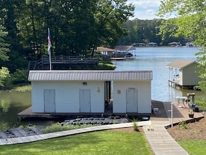 Paddles, life jackets, paddle board are stored in the shed on the right