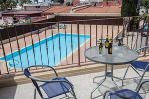 Balcony with seating area overlooking the pool