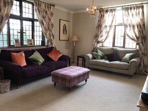 One of two reception rooms - smart TV, DVD player and board games in footstool.