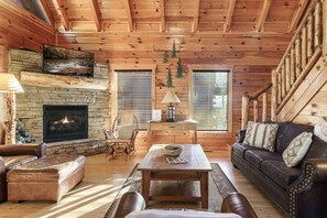 Spacious, cozy living room with rustic cabin style decor throughout.