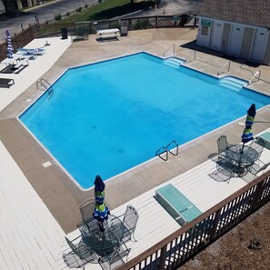 Arial view of the resort's large outdoor pool, hot tub, and seating areas!