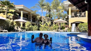 Pool area with main pool for adults, one pool for kids, and a jacuzzi.