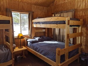 Two sets of bunk beds, and one of the bunks has a full-sized lower bunk. 