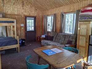 Couch, small dining table, and chairs. Lots of windows!