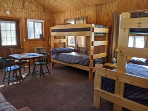 Two sets of bunk beds, and one of the bunks has a full-sized lower bunk. 