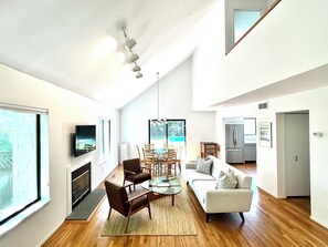 Living and dining area with modern furnishings and Ultra 4K Smart TV.