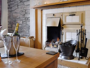 Feature fireplace within the living room | Baldowrie Farm Cottage, Kettins, near Blairgowrie