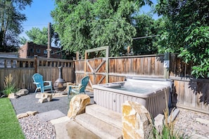 Backyard | Hot Tub, Shaded Lounge Area and Chiminea