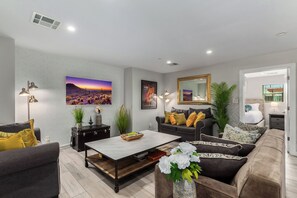 Warm & inviting designer furnished living room featuring a Smart TV for entertainment pleasure.