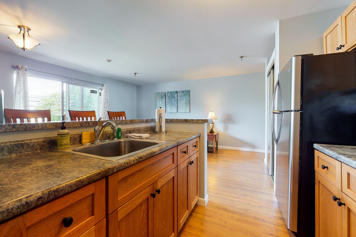 Inviting condo in quiet locale with partial lake views, balcony & grilling area