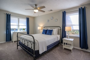 Oversized master bedroom with king size bed well suited for two.
