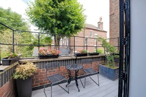 Enjoy some fresh air and a morning cup of tea  on this pretty balcony
