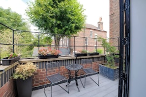 Enjoy some fresh air and a morning cup of tea on this pretty balcony