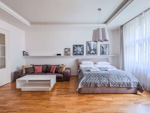 Bedroom with a street view - king-size bed and sofa