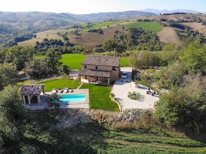 Aerial view of Casa Pace e Gioia with the Sibillini mountains in the background