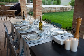 The outdoor dining table ready for dinner overlooking the sunset.