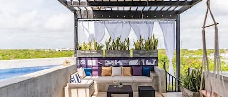 Private rooftop lounge with plunge pool and swings