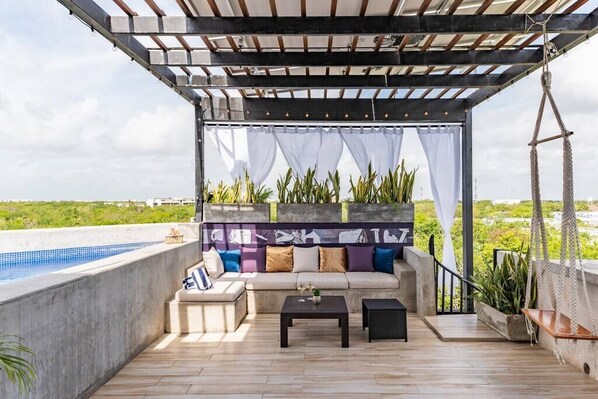 Private rooftop lounge with plunge pool and swings