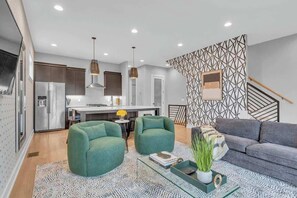 The large open living room features plenty of seating with 2 sofas, and 2 arm chairs and plenty of space to spread out and relax.