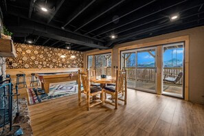 Game room with pool table, custom wood slice accent wall, log game table & deck!