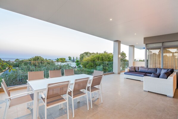 Enjoy treetop and ocean glimpses while dining or lounging in this open-air entertaining space.
